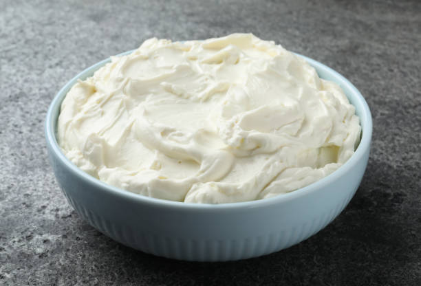 istock Bowl of tasty cream cheese on grey table 1425557429