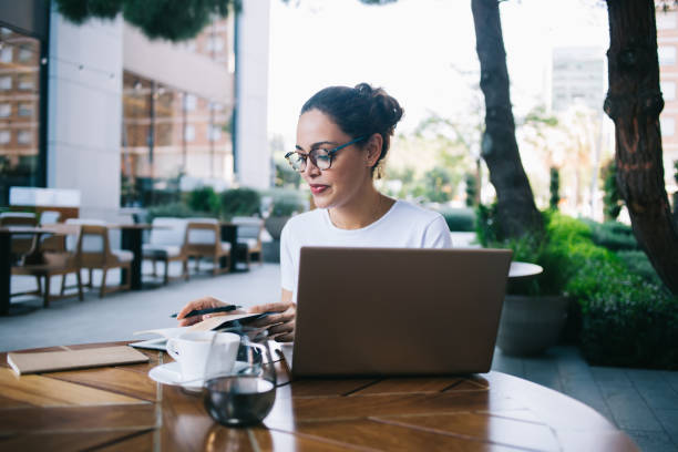 istock Busy woman taking notes on summer terrace in cafe 1425557601