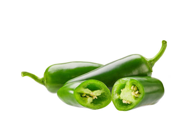 whole and chopped green jalapeno pepper isolated on white background. stock photo