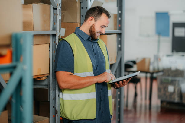 istock Logistics worker doing inspection with tablet, planning cargo delivery and working at distribution warehouse at work. Manufacturing manager, employee and man doing stock check and shipping product 1425560603