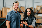 Logistics, ecommerce and people in a warehouse portrait with tablet for stock inventory or package management app. Happy employees, workers or manager working in b2b business or supply chain industry