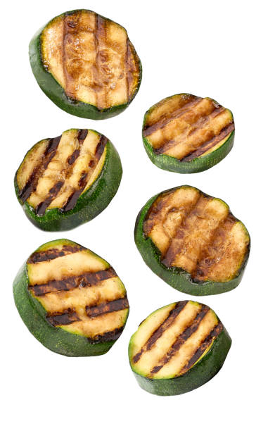 istock falling grilled sliced zucchini isolated on white background. 1425560686