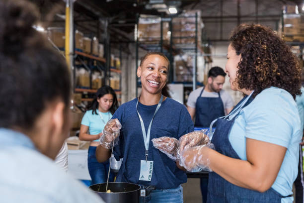 Multiracial group work at the food drive The multiracial group works at the food drive volunteering to serve those in need. soup kitchen stock pictures, royalty-free photos & images