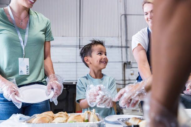 istock Young boy smiles as he helps prepare sandwiches 1425562534