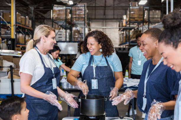 istock Diverse group enjoys working together at food bank event 1425563051