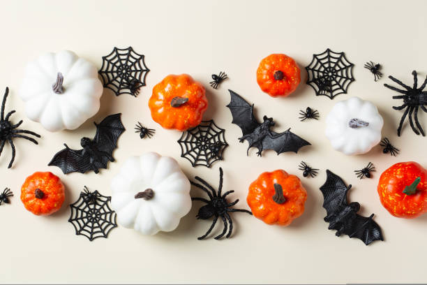 istock Halloween greeting card with bats, spiderweb, spider, skull and pumpkins 1425563353