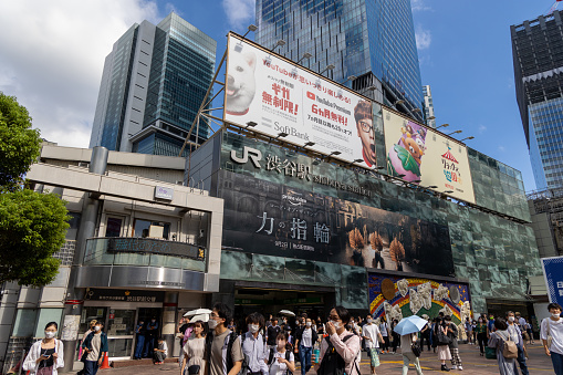 Tokyo, Japan - September 3, 2022 : People walk past the Shibuya Station, Tokyo, Japan. Shibuya Station is one of busiest train station in Tokyo.