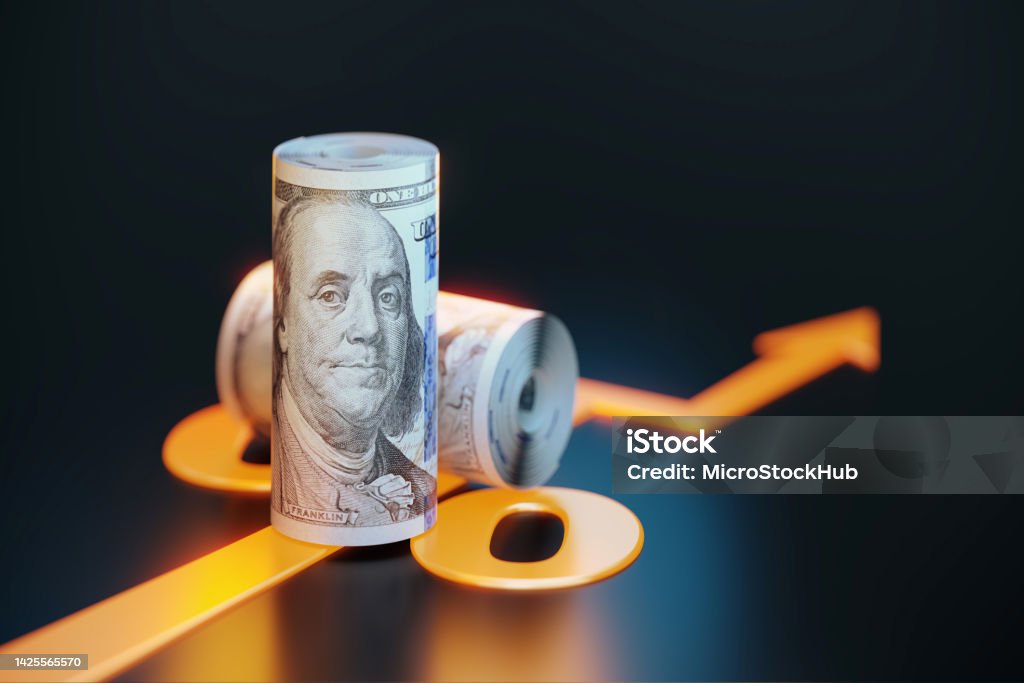 Rolled Up 100 American Dollar Bills Sitting Over Orange Colored Arrow Symbol On Black Background Rolled up 100 American Dollar bills sitting over orange colored arrow symbol sitting on black background. Horizontal composition with copy space. Finance concept. Dollar Sign Stock Photo