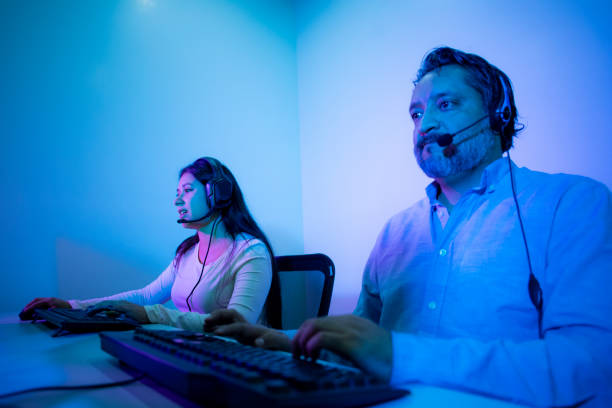 istock man and woman working in call center 1425565705