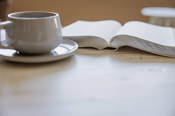 Coffee and open bible on white wood table stock photo