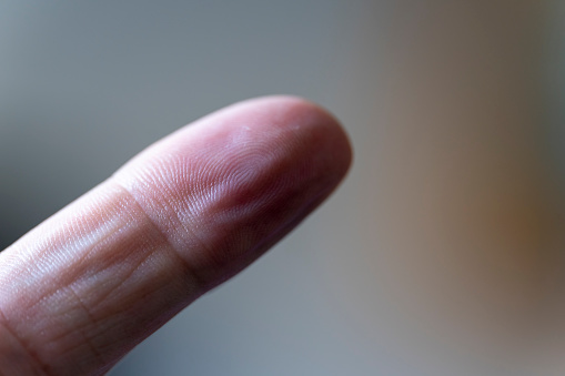 A senior man's index finger on left hand