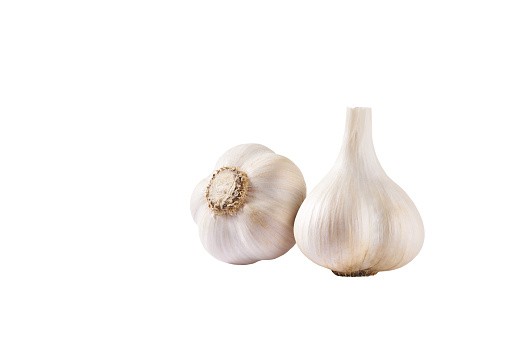Unpeeled two garlic bulbs isolated on white background.