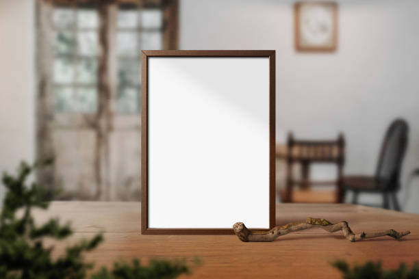 istock Clean minimal frame mockup standing on wooden top table with plants 1425573955
