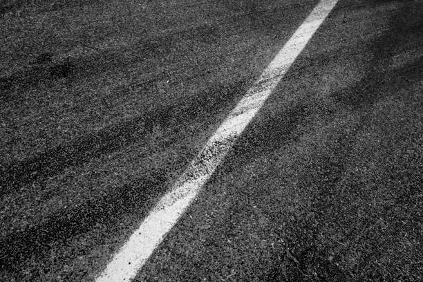 Skid Marks or Tire Tracks on Road Detail of skid marks or tire tracks on road street skid marks stock pictures, royalty-free photos & images