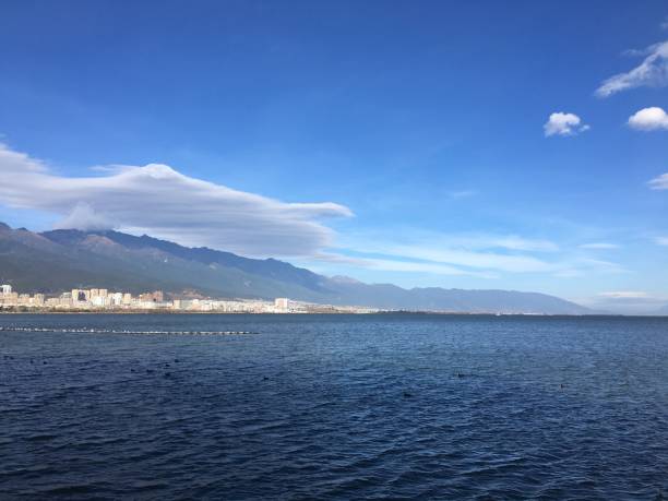istock Erhai blue sky and white clouds distant mountains 1425574512