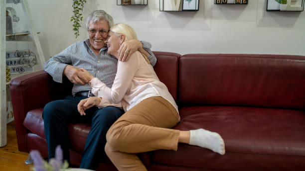 istock senior couple relaxing on the couch at home 1425575291