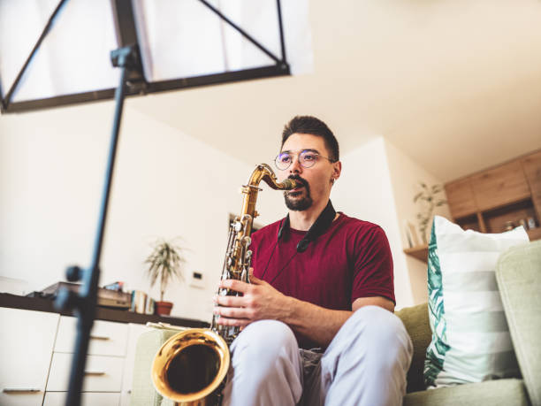 istock Young male musician practising saxophone at home 1425577147