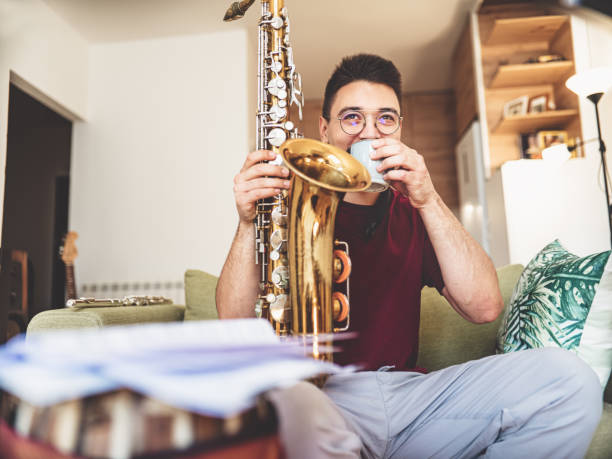 istock Young male musician taking a coffee break from practising at home 1425577182