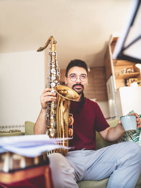 istock Young male musician taking a coffee break from practising at home 1425577218