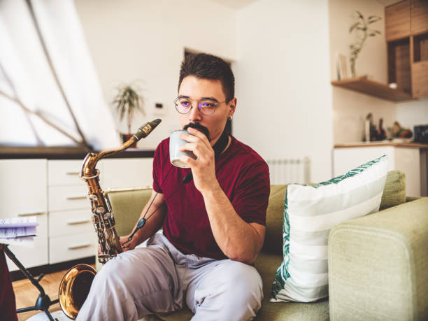 istock Young male musician taking a coffee break from practising at home 1425577319