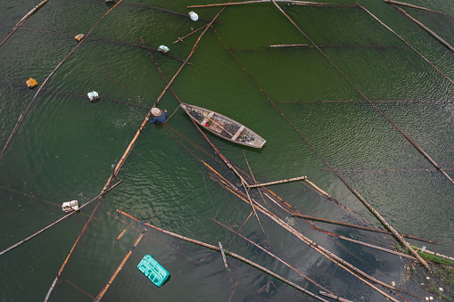 Drone view a fisherman on Quan Tuong river is catching fish - Nha Trang city, Khanh Hoa province, central Vietnam