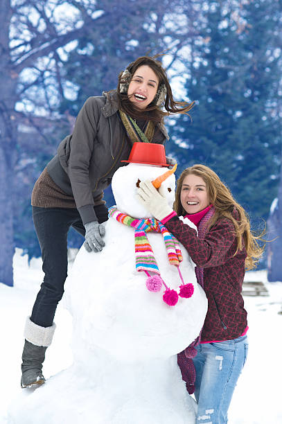 istock Girls building a snowman 142557756