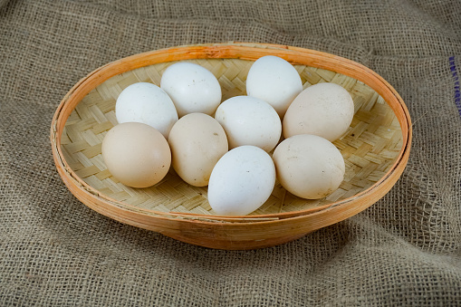 Pet Chicken Eggs in a tray of woven bamboo on burlap