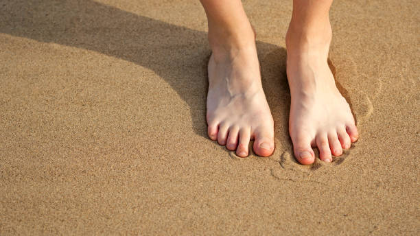 istock Woman barefoot on sand 1425582117