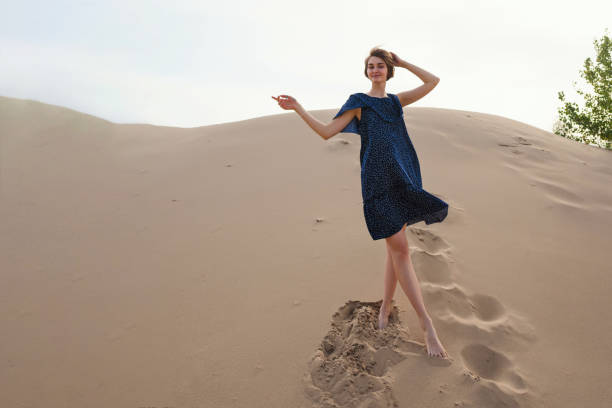 istock Romantic girl posing sandy dunes 1425582133