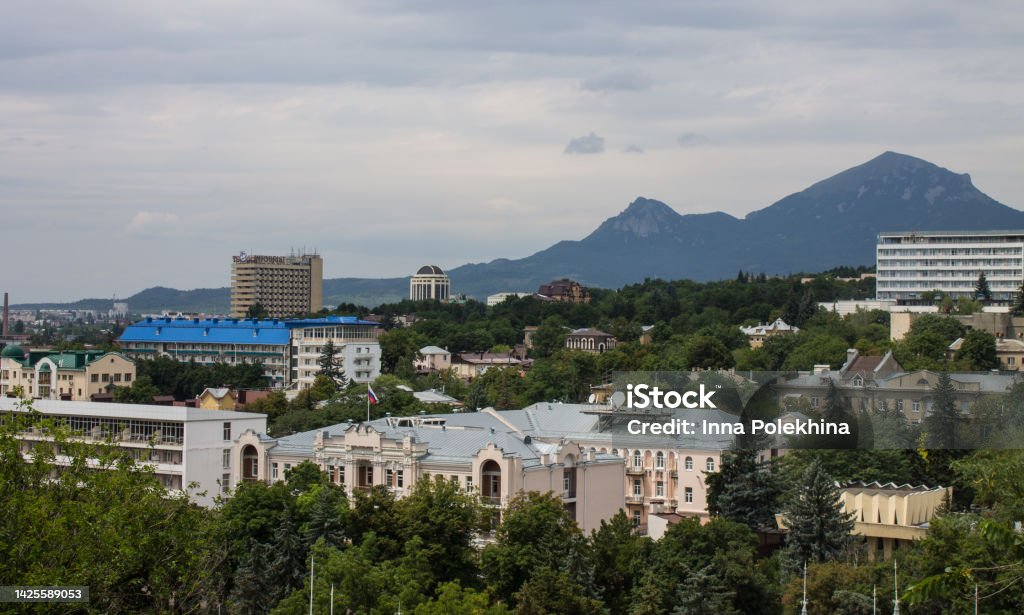 top view of the historical part of Pyatigorsk Cityscape - panoramic top view of the historical part of Pyatigorsk in Russia with buildings and green trees against the background of Mount Beshtau on a cloudy summer day Adventure Stock Photo