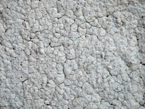 istock Cracked old plaster on the exterior wall, close up shot 1425591321