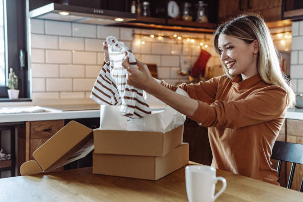 istock Satisfied young woman opening her online order 1425593979