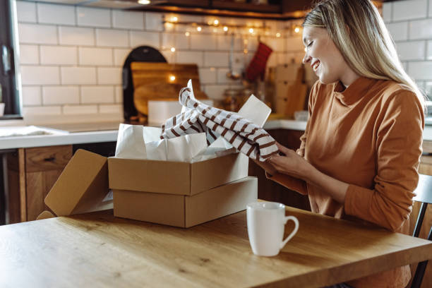 istock Satisfied young woman opening her online order 1425594121