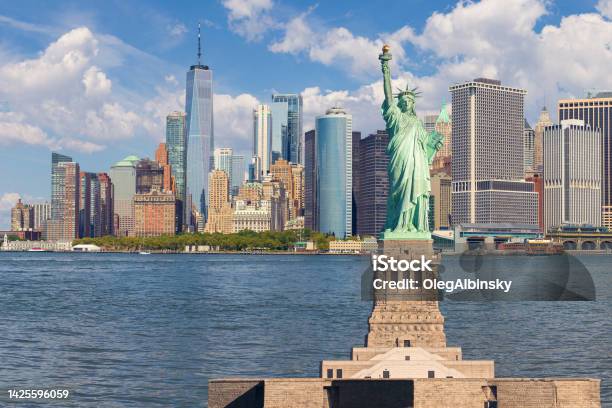 Statue Of Liberty And New York City Skyline With Manhattan Financial District World Trade Center And Blue Sky With Clouds Stock Photo - Download Image Now