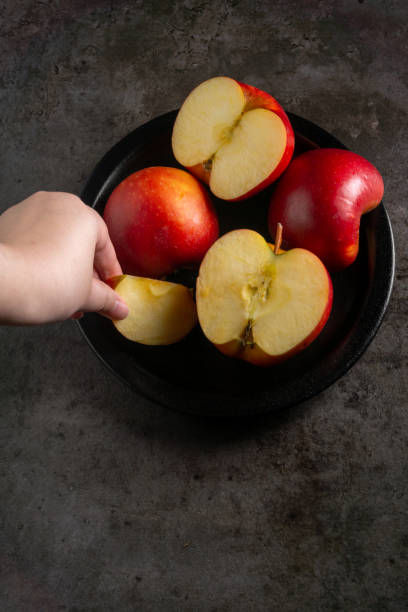 istock Apples in a dramatic low key concept with a dark background in variety angles 1425597783