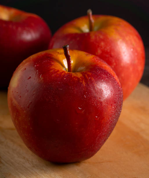 istock Apples in a dramatic low key concept with a dark background in variety angles 1425598654