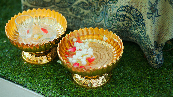 Golden bowls with water at Thai Songkhran