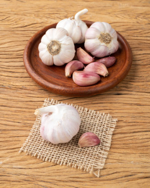 istock Garlic bulb and cloves on a plate over wooden table 1425600032