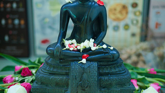 Thai Buddhist flower Songkhran decor at black Buddha