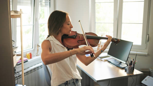 istock Young female violinist practicing at home 1425601469