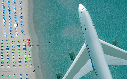 plane flying over the beach