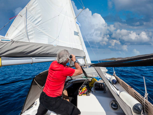 a man watches the environment on the autopilot boat. - yacht nautical vessel autopilot sailing imagens e fotografias de stock