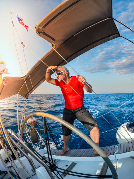 a man watches the environment on the autopilot boat. - yacht nautical vessel autopilot sailing imagens e fotografias de stock