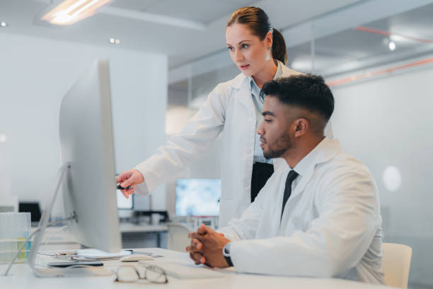 istock Science, medicine and research in a lab with a scientist and analyst working as a team on innovation and development. Technology, collaboration and analytics with a man and woman in a laboratory 1425605790