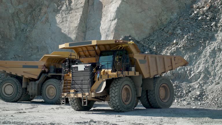 Operator Driving Heavy Dump Truck Mining Equipment At Gold Mining Field, slow motion