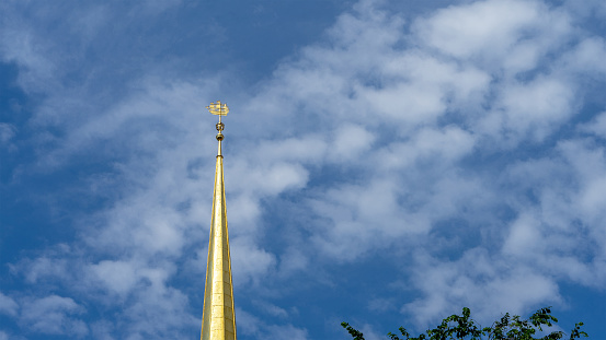 Ship on the spire of the Admiralty building against the sky with clouds, St. Petersburg, Russia. Copy space for text.