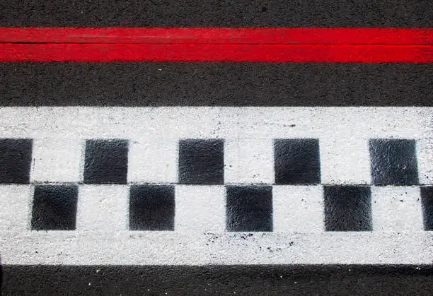 Photo of Asphalt background checkered sign, concepte of race competition finish