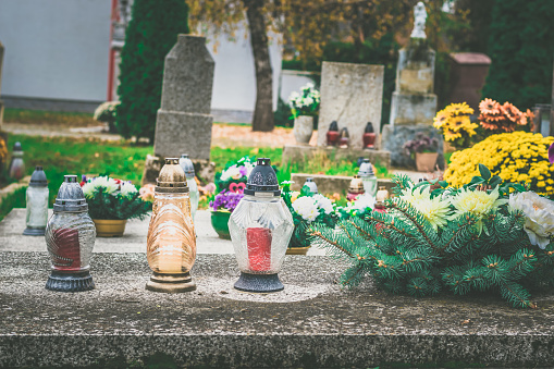 colorful decoration and burning candles in the cemetery