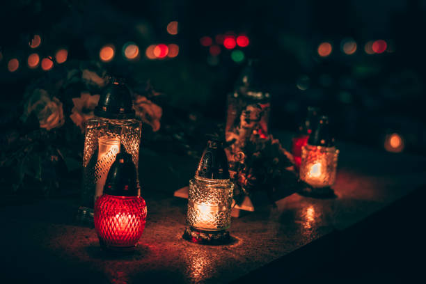 istock burning candles at night in the cemetery 1425613086