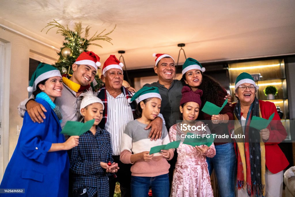Family together singing christmas carols at home Christmas Stock Photo